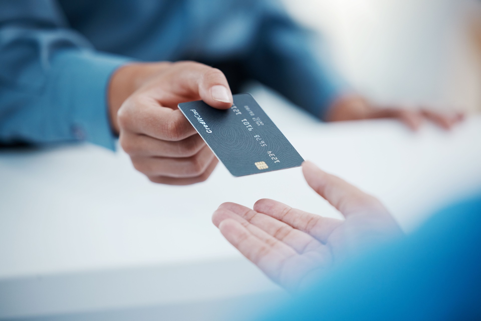 Corporate hands exchange credit card to accountant for payment for company tax bills, money loan and accounting fees. Businessman with banking card to invest in financial savings budget investment